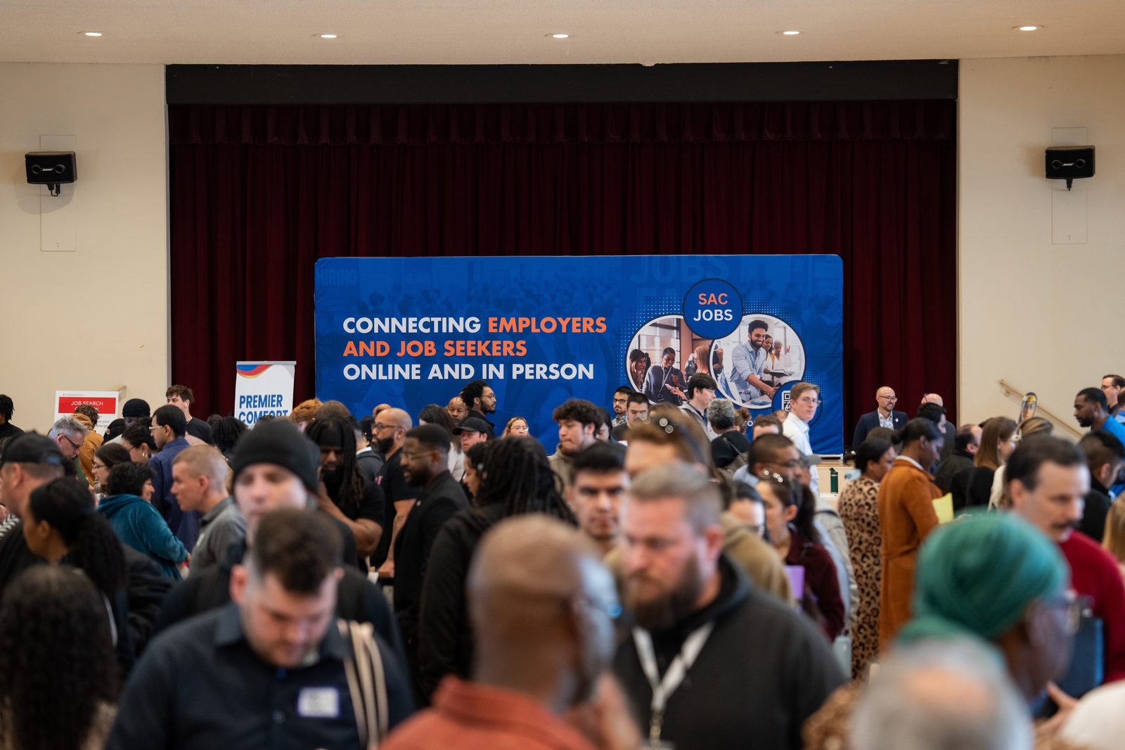 Packed crowd at SacJobs Career Fair with the SacJobs banner