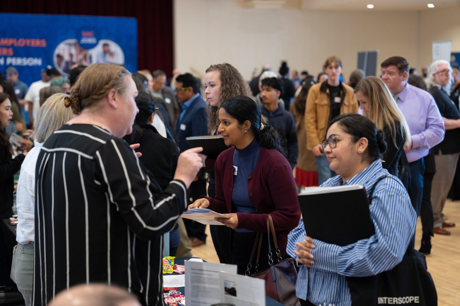 Multiple Candidates engaging with employers at SacJobs Career Fair