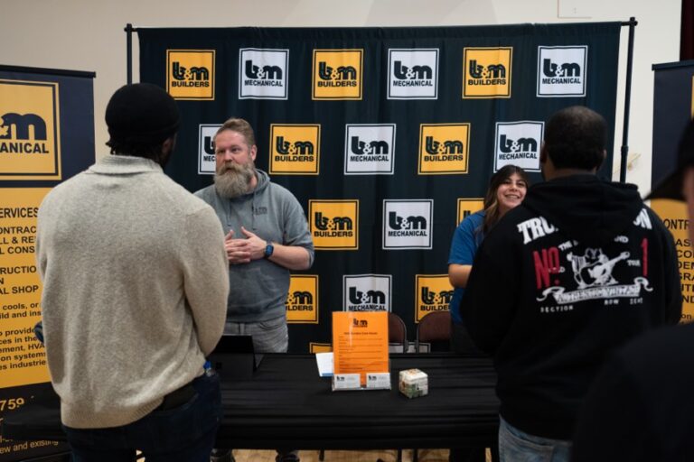 A contractor talks with Candidates at a SacJobs career fair